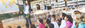 Image: A teacher leads a class of elementary aged children in a lesson